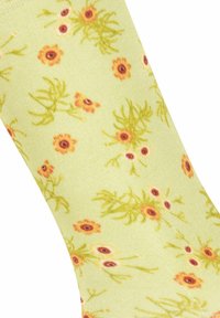 Hellgrüne Socken mit einem floralen Muster aus gelben und orangen Blumen, verziert mit braunen Zentren und grünen Stielen. Weiche Textur.