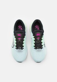 Sneakers Nike Zoom Fly 5 con tomaia in mesh color menta chiaro, chiusura con lacci neri, dettagli rosa e suola bianca liscia.