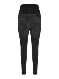Black maternity skinny jeans with elastic waistband and two back pockets, shown from the back on white background.
