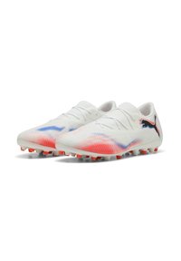 White soccer cleats with gradient red and blue accents, textured upper, lace-up design, and orange studded outsole for traction.
