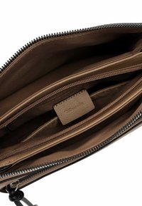 Brown leather pouch with a zipper closure, featuring multiple interior compartments and a smooth texture. Brand label visible inside.