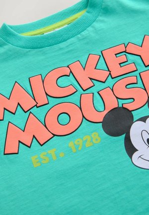 Tyrkysové bavlněné tričko s výrazným korálovým nápisem "MICKEY MOUSE" a grafikou Mikey Mouse v černobílé barvě.