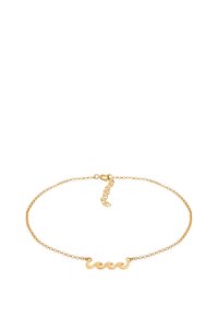 Pulsera de cadena de oro delicada con un pequeño adorno central en forma de ola y cierre ajustable sobre un fondo blanco.