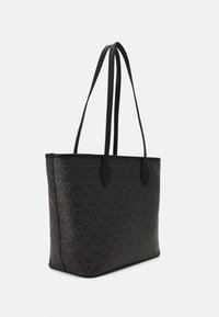 Black tote bag with a textured pattern featuring repeating triangular logos. Smooth leather straps and a structured rectangular shape.