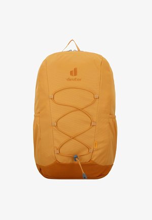 Mochila de tela amarilla con diseño de cordón elástico en el frente, bolsillos laterales y un asa en la parte superior. Presenta un logo de marca bordado en el frente.