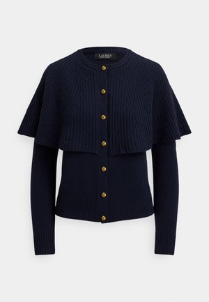 Cardigan bleu marine avec texture côtelée, présentant un design de cape superposée, des boutons dorés et des manches ajustées avec poignets côtelés.
