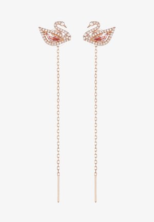 Uhani iz rožnatega zlata v obliki laboda z kristalnimi detajli in zasnovo povezanega nakita. Imajo edinstveno obliko in bleščeče podrobnosti. Dolžina verige se razlikuje.