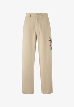 Pantaloni di cotone beige con vita alta, gamba dritta e un design ricamato sul lato sinistro che presenta un motivo colorato.