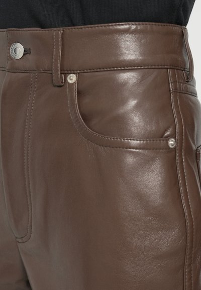 Brown leather pants with a smooth texture. Features a waistband with a silver snap closure, side pockets, and stitching details.