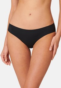 Svarta bikiniunderdelar i mjukt, sträckt tyg. Har en sömlös design och en måttlig midjehöjd med en slät, matt yta.
