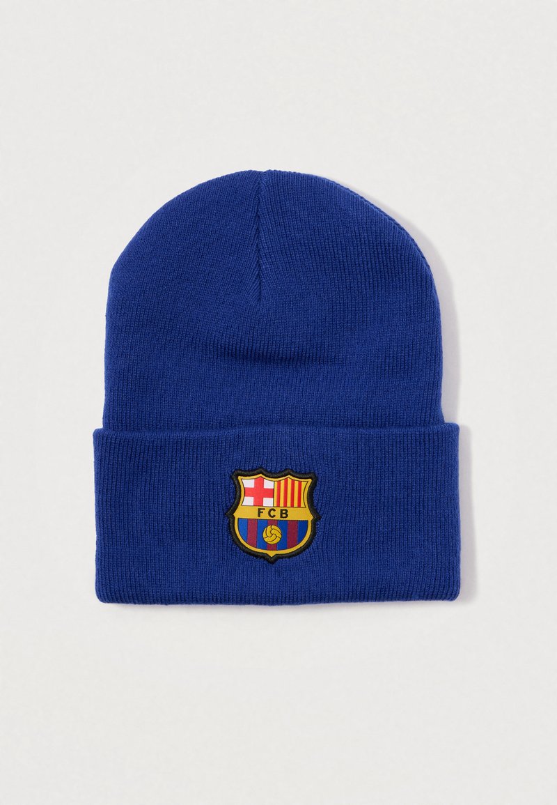Gorro de punto azul con dobladillo. Presenta un bordado del escudo del FC Barcelona en colores rojo, amarillo y negro en la parte frontal.
