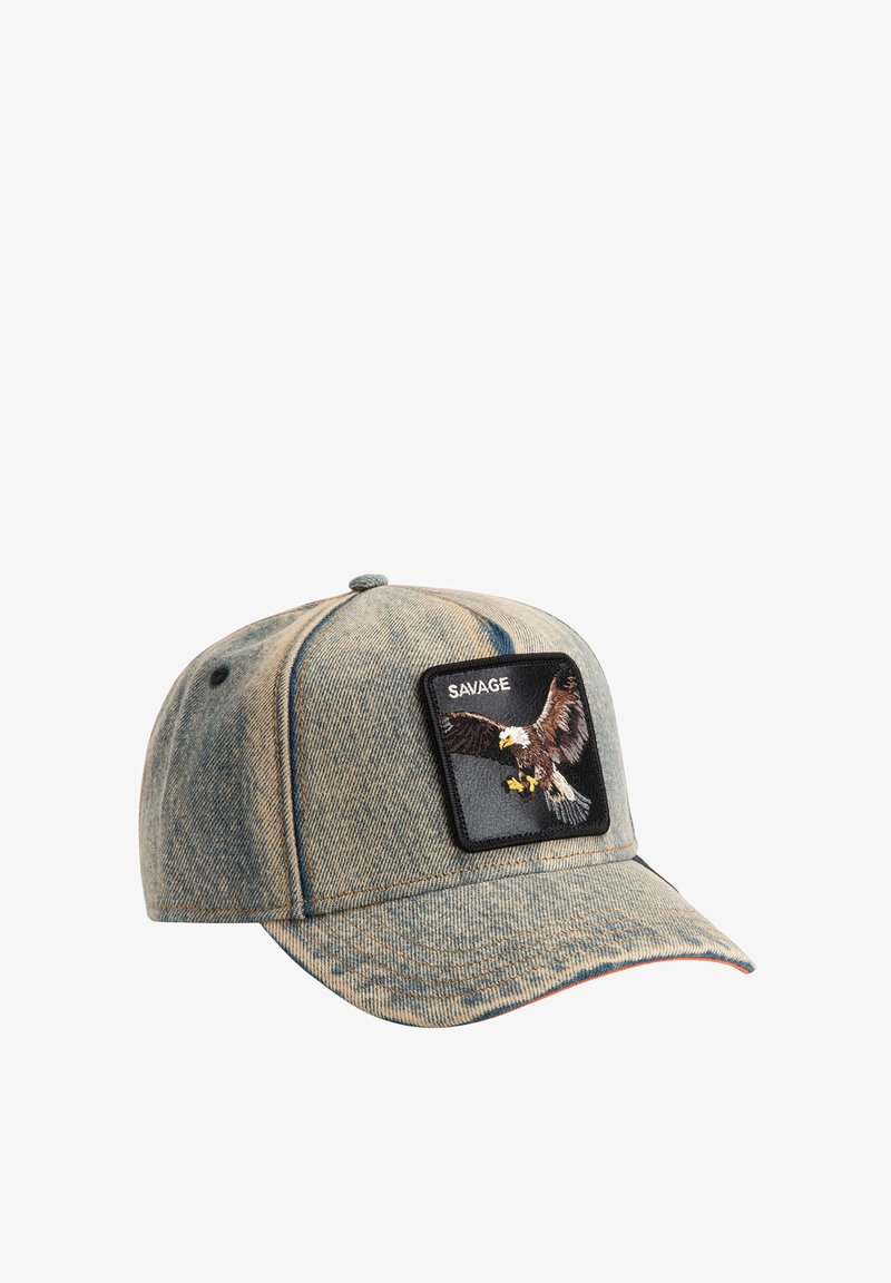 Denim baseball cap with a rounded crown, black patch featuring a flying eagle, stitched details, and a curved visor. Accent stitching in red.