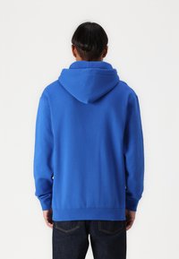 Blue sweatshirt with a hood, featuring a smooth texture and ribbed cuffs and hem. A simple, classic design without any visible logos.
