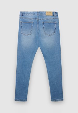 Jeans in denim azzurro chiaro con una vestibilità aderente, dotati di due tasche posteriori e di un'etichetta in pelle con marchio sulla vita.