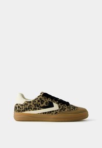 Leopard print sneaker with a suede and leather upper, black laces, cream accents, and a textured rubber sole.