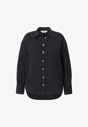 Chemise surdimensionnée sombre avec col et boutons dorés décoratifs sur le devant, en tissu texturé, avec un ourlet arrondi.