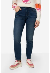 Tmavě modré džíny se slim fit, s tradičními kapsami a zipem. Skvěle se hodí k módním, vícebarevným teniskám.