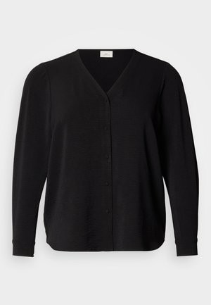 Cardigan noir à manches longues avec col en V, tissu texturé, fermeture à six boutons et fentes latérales pour faciliter les mouvements.