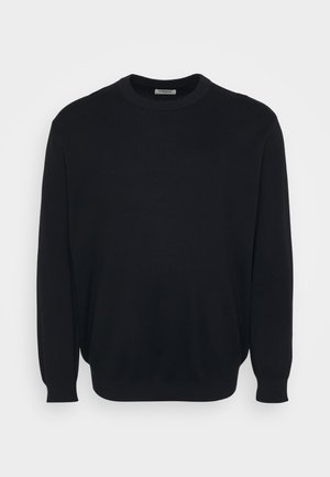 Crna dolčevita od mekog pletenog materijala. Dugi rukavi s uskim rukavima, jednobojna, opuštenog kroja.