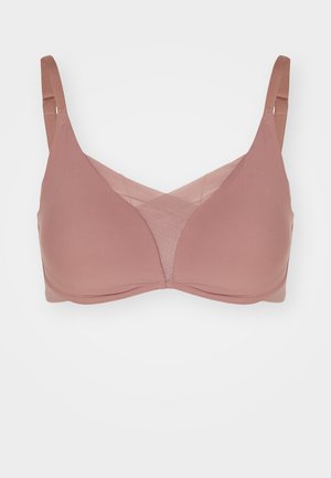Rose-colored wireless bra with soft fabric, mesh inserts, and adjustable straps. Features a smooth, seamless design and no underwire.