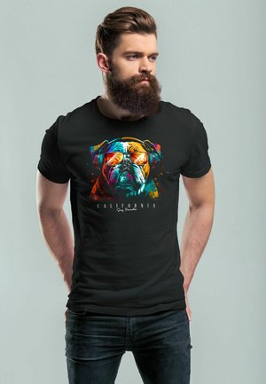 Black t-shirt featuring a colorful bulldog graphic with sunglasses and headphones. The design includes splashes of blue, orange, and yellow.