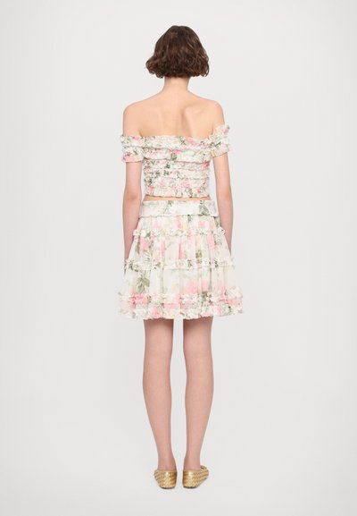 Off-the-shoulder floral crop top and tiered mini skirt in light colors with ruffled accents; features a fitted design and elastic waistband.