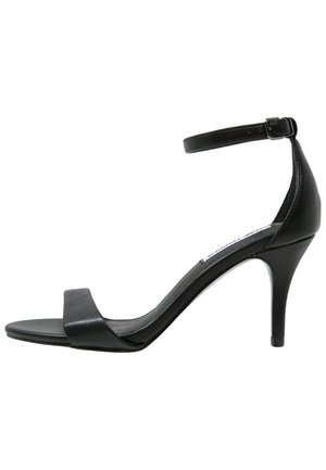Black leather high-heeled sandal with ankle strap and open toe, shown in profile against a white background.