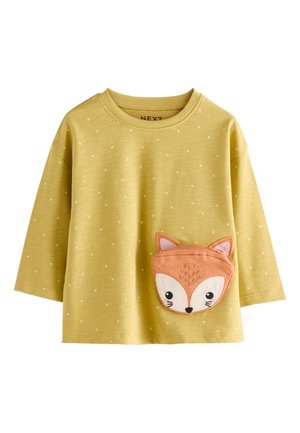 Maglietta a maniche lunghe gialla con pois bianchi e tasca a forma di volto di volpe. Tessuto morbido con scollo arrotondato e vestibilità comoda.