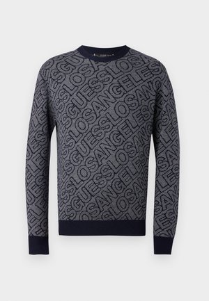 Mornarsko modra pulover s drznim celovitim vzorcem besedila "Guess Los Angeles" v kontrastni temno modri barvi, z rebrastim ovratnikom, manšetami in robom.