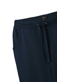 Granatowe spodnie dresowe wykonane z miękkiego materiału, z elastycznym paskiem w talii z dodatkiem sznurków, bocznymi kieszeniami oraz luźnym krojem.