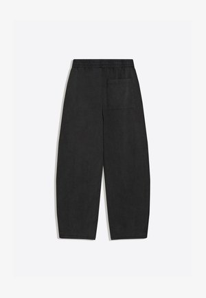 Schwarze locker sitzende Hose mit elastischem Bund und einer einzelnen aufgesetzten Gesäßtasche, flach auf weißem Hintergrund dargestellt.