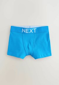 Blå bomullsboxershorts med ett vitt elastiskt midjeband med "NEXT" tryckt framträdande. Slät textur, kort bendesign och inga synliga mönster.