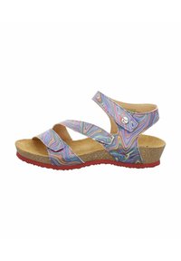 Multicolored sandal with cross straps, cork footbed, and red rubber sole. Features a swirling, pattern on synthetic upper material.