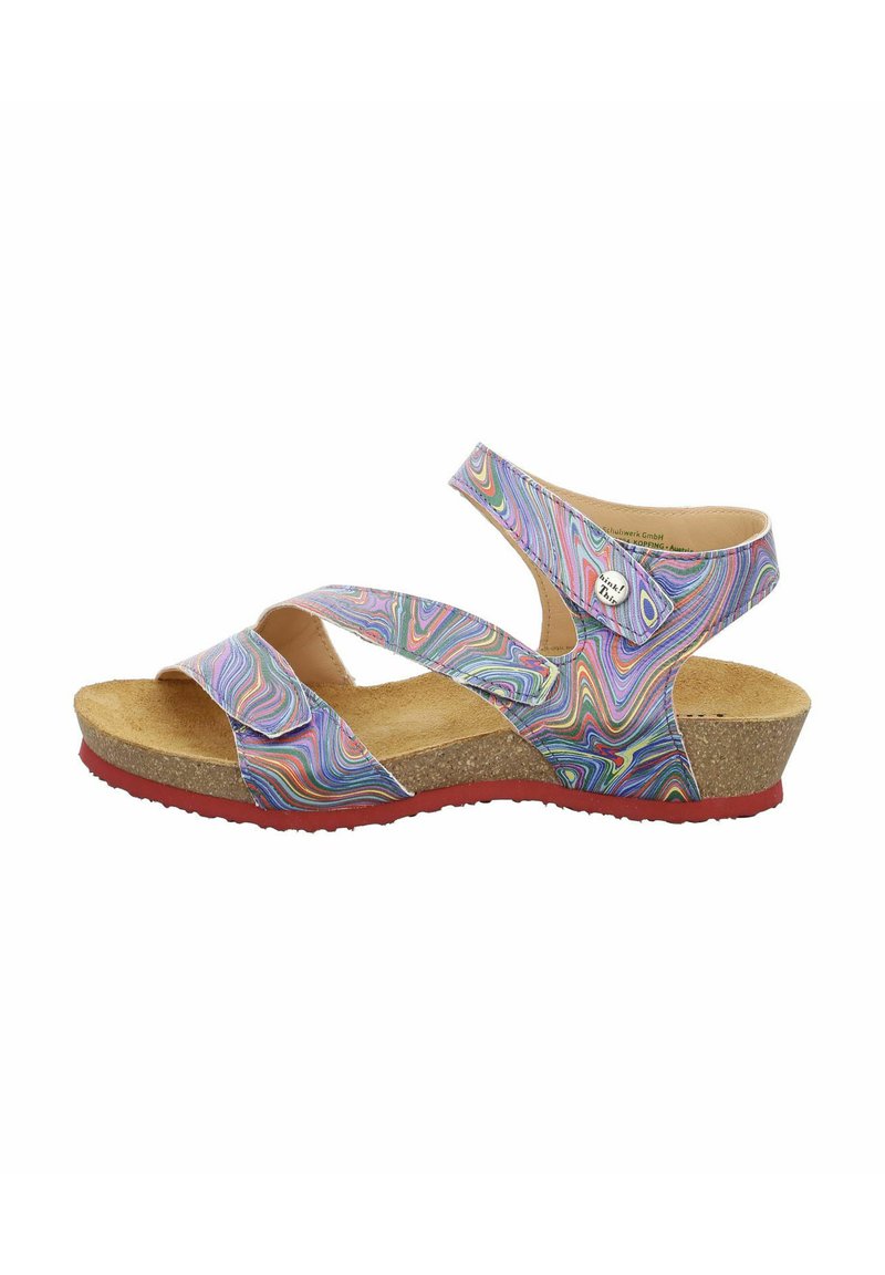 Multicolored sandal with cross straps, cork footbed, and red rubber sole. Features a swirling, pattern on synthetic upper material.