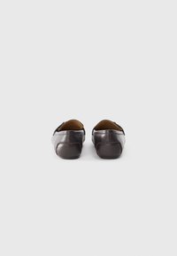 Brown leather shoes with a smooth texture, rounded shape, and minimal stitching details. Back view showcases the heel and soft lining.