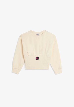Felpa corta a maniche lunghe color crema, realizzata in tessuto morbido. Presenta un punto vita arricciato e una patch logo nera con dettagli rosa sul davanti.