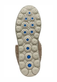 Suela de zapato con un material de color crema, patrones texturizados redondos y círculos en azul. Marca grabada en la suela.