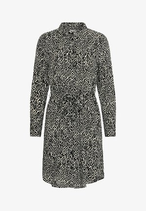 Zwart-wit gestreepte jurk met lange mouwen, kraag, knoopsluiting en een strikdetail in de taille. Heeft een diamanten geometrisch design.