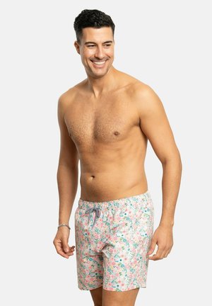 Los bañadores con estampado presentan un diseño floral en tonos rosas con acentos verdes. Están hechos de un material liviano, cuentan con una cinturilla elástica y cordones.