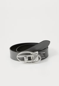 Black leather belt with a wide, shiny silver oval buckle featuring a distinctive cut-out design. Textured strap with multiple adjustment holes.