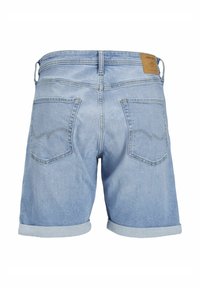 Light blue denim shorts with rolled cuffs, two back pockets, belt loops, and a tan leather brand patch on the waistband.