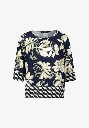 Marineblaue Bluse mit kurzen Ärmeln, verziert mit weißen und olivgrünen Blumenmustern sowie einem wellenförmigen, gestreiften Saum am unteren Rand. Glatte Stofftextur.