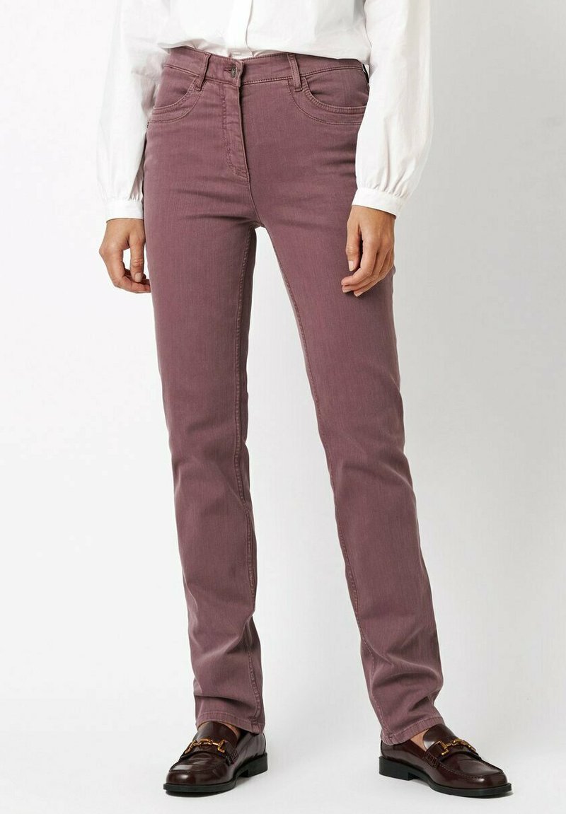 Purple cotton blend jeans with a slim fit, five-pocket design, and subtle stitching details, paired with dark loafers and a white blouse.