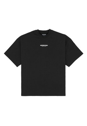Black cotton t-shirt featuring short sleeves and a crew neck. Displays a white "WRSTBHVRSTUDIO" logo across the chest. Simple design.