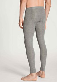 Leggings grigi con una vestibilità aderente, superficie liscia e vita media, caratterizzati da una cucitura sul retro.