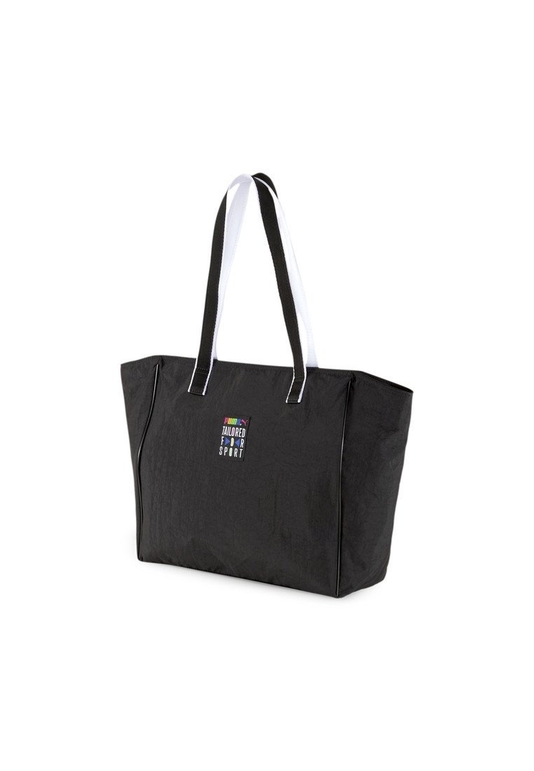 Czarna torba na ramię z białymi uchwytami, z małym, wielokolorowym logo "PUMA Tailored for Sport" na przednim środku.