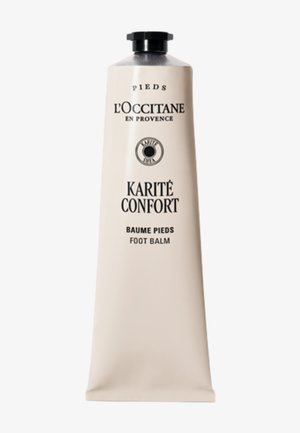 Balsamo per i piedi al burro di karité L'Occitane in un tubo beige opaco con tappo nero. Presenta testo in rilievo e un logo circolare al centro.