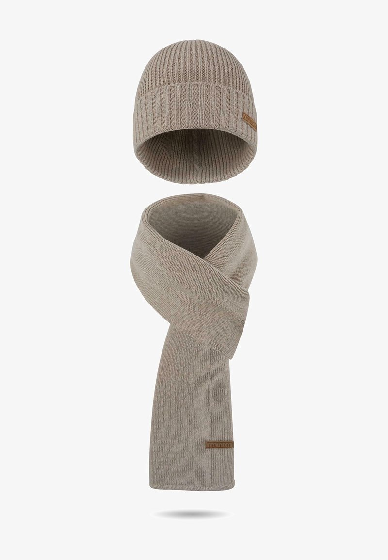 Beiges gestricktes Mütze- und Schal-Set. Mit geripptem Textur und einem Leder-Logo-Patch auf dem Schal. Beide Artikel sind weich und warm.