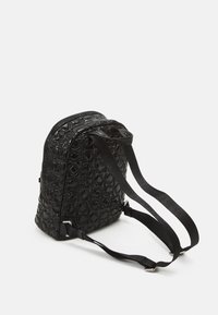 Czarny plecak wykonany z teksturowanego materiału, o zaokrąglonym kształcie, z regulowanymi paskami na ramiona oraz tłoczonym wzorem logo na całej powierzchni.