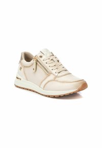 Zapatilla de un beige claro con un exterior de cuero suave, parte delantera con cordones y detalle de cremallera lateral. Suela acolchada y suela exterior de goma marrón.